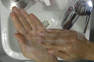 image of cleaning left palm over the sink
