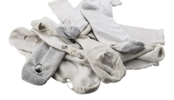 Pile of old white socks with holes