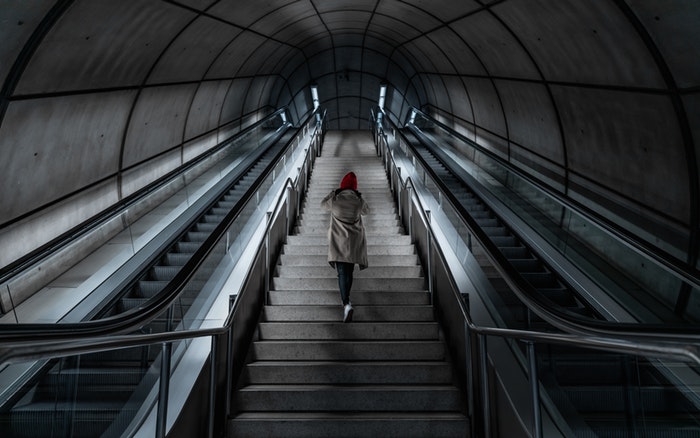 Person climbing stairs in a metro station