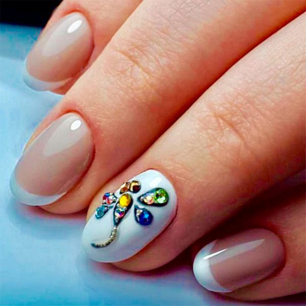 Cute round modern french nails with an accent white round nail adorned with crystal